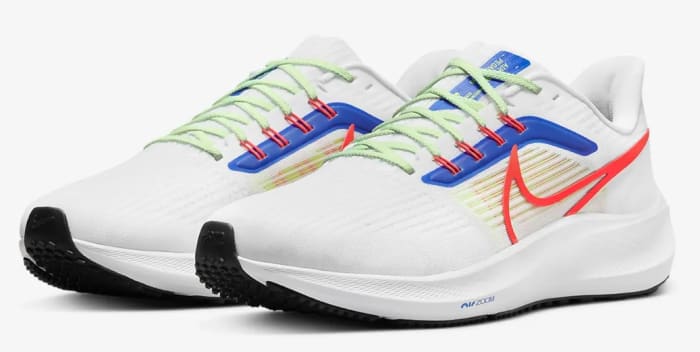 View of white, red, and blue Nike shoes.